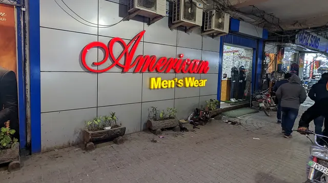 The red American Men's Wear sign inside Barkat Plaza