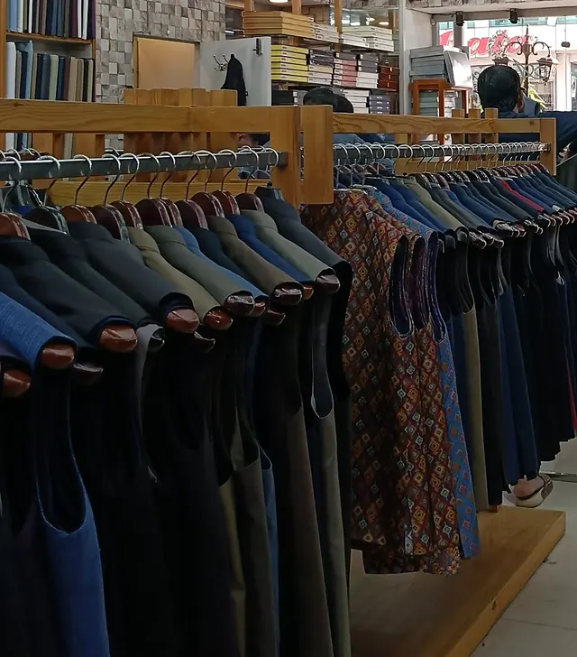 A rail of waistcoats in navy, charcoal, blue and printed styles